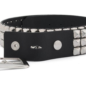May include: A black leather belt with three rows of silver pyramid-shaped studs.