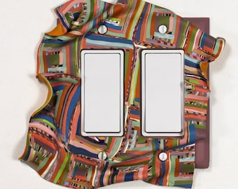 Handmade polymer-clay double-rocker light-switch plate cover in multiple colors including purple, pink and orange. One of a kind. Jazzy