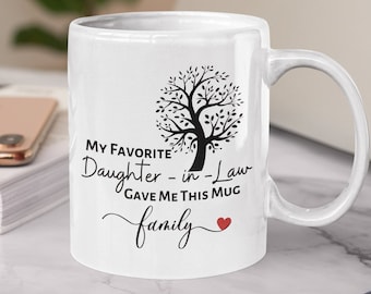 May include: White ceramic mug with a black and white tree design and the text "My Favorite Daughter-in-Law Gave Me This Mug family" with a red heart.