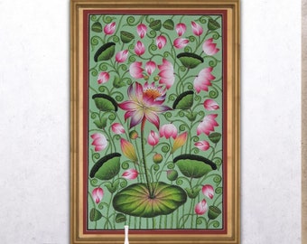 May include: A framed painting of a pink lotus flower with green leaves and stems on a light green background. The painting is in a gold frame and is hanging on a white wall.