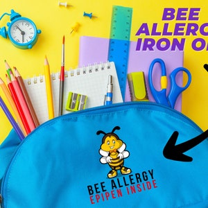 May include: Blue backpack with a bee allergy iron-on patch that says "Bee Allergy EpiPen Inside". The backpack is filled with school supplies, including pencils, a ruler, a notebook, and a pair of scissors.