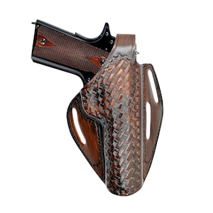 May include: A brown leather holster with a woven pattern, holding a semi-automatic pistol. The pistol has a dark brown grip with a diamond pattern. The holster has cutouts and a dark brown border.