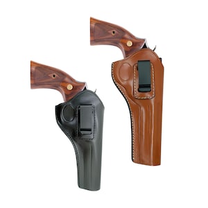 May include: Two leather gun holsters, one black and one brown, each holding a revolver. The holsters have a clip for attaching to a belt. The revolvers have wooden grips with a gold emblem.