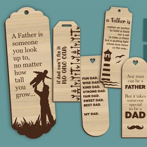 May include: A collection of wooden Father's Day bookmarks with various quotes and designs. One bookmark features a silhouette of a father and child, while others have lighthouse, mustache, and tool motifs. The bookmarks are light brown with dark brown text.