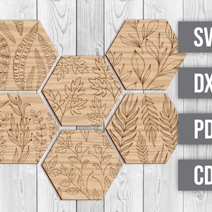 May include: Six hexagonal wooden coasters with laser-cut designs of various leafy patterns. The coasters are arranged in a honeycomb pattern.