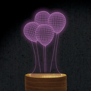 May include: A pink LED night light shaped like a cluster of balloons. The light is on a wooden base.
