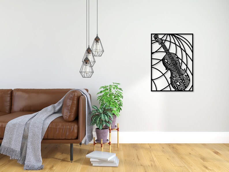 May include: Black metal wall art featuring a detailed, intricate design of a violin. The violin is set against a background of curved lines, creating a dynamic and modern aesthetic.