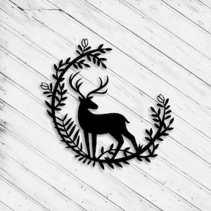 May include: Black silhouette of a deer standing in a wreath of leaves and flowers.