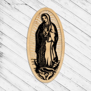 May include: A wooden cutout of the Virgin Mary in an oval frame. The cutout is black and features a detailed design of the Virgin Mary's robes and the surrounding scene.