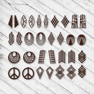 May include: A set of 30 laser cut earring designs, featuring geometric shapes, patterns, and symbols. The earrings are made of wood and are brown in color.