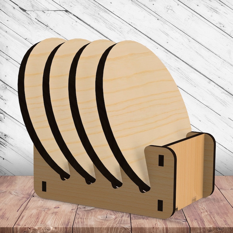 May include: A wooden coaster rack with five round wooden coasters. The rack is made of light brown wood and has a simple design. The coasters are stacked on top of each other and are ready to be used.
