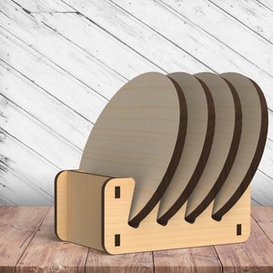 May include: A set of four wooden coasters with a natural finish, stacked in a wooden holder. The holder has a simple design with a cutout for each coaster.