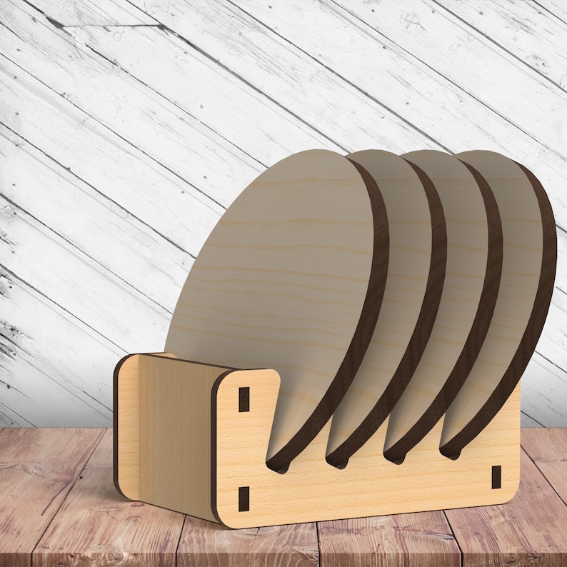 May include: A set of four wooden coasters with a natural finish, stacked in a wooden holder. The holder has a simple design with a cutout for each coaster.