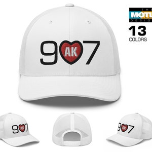 May include: White trucker hat with a black embroidered design that says "907" with a red heart and the letters "AK" inside the heart.