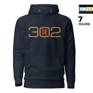 May include: A navy blue hoodie with a gold and orange graphic that says "302 DE".