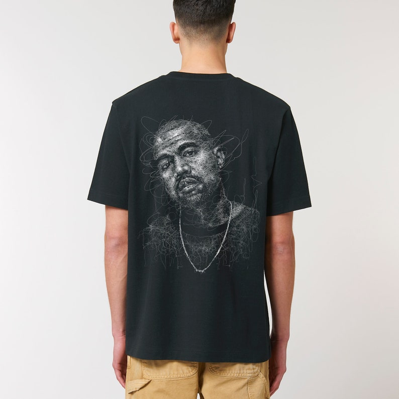 Pu&ograve; includere: T-shirt nero con un disegno a linea bianca di un viso maschile sul retro.