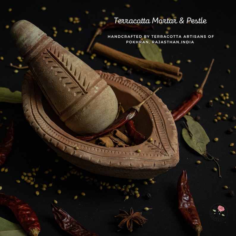May include: Terracotta mortar and pestle set with spices, including red chili peppers, cinnamon sticks, bay leaves, and coriander seeds. Handcrafted by terracotta artisans of Pokhran, Rajasthan, India.