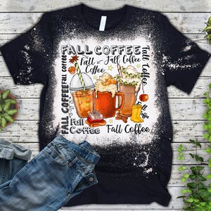 May include: Black t-shirt with a white bleach design featuring fall-themed coffee drinks, leaves, and the text "Fall Coffee".