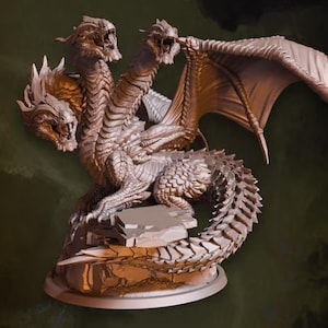 May include: A three-headed dragon figurine with wings outstretched, standing on a rocky base. The dragon is sculpted in a light brown color and has a detailed, scaly texture.