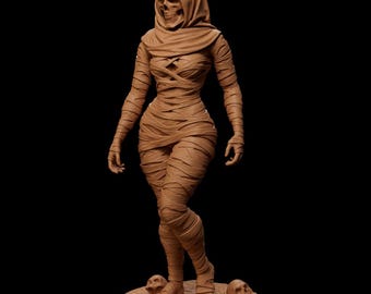 May include: A brown mummy sculpture with a skull face and wrapped in bandages. The figure is standing on a round base with skulls and a bone. The sculpture is a detailed representation of a mummy.