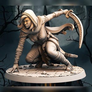 May include: A detailed figurine of a female warrior in a hooded cloak, poised in a crouched stance. She holds a curved blade with intricate designs. The figure is set against a backdrop of a full moon and bare tree branches.