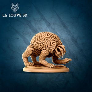 May include: A tan-coloured, 3D-printed creature with a brain-like head and clawed limbs. The figure is posed on a circular base. The logo "LA LOUVE 3D" is in the upper left corner.
