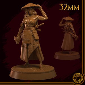 May include: A brown resin figurine of a female warrior in a straw hat and armour, holding a mask. The figure has two swords and is standing on a round base. The text "32MM" is visible.