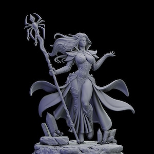 May include: A detailed gray figurine of a female fantasy character, holding a staff with a spider-like emblem. She wears a flowing gown and has long, flowing hair. The figure stands on a rocky base with crystal formations.