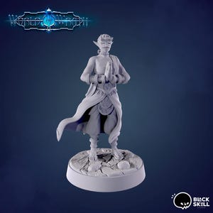 May include: A grey painted miniature figurine of a humanoid figure with pointed ears, wearing a long robe and holding their hands together in a prayer position. The figure is standing on a circular base with a textured surface.