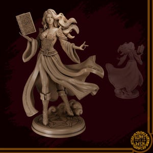 May include: A beige resin statue of a woman holding a book and gesturing with her right hand. She wears a long dress, boots, and has long flowing hair. A smaller, darker version of the statue is to the right. The base has a circular design.