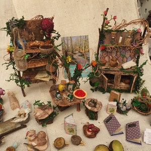 Fairy house kitchen - stove, table with stools and a set of shelves that are full of items.