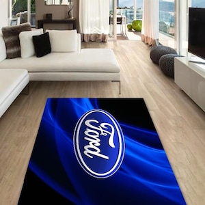 May include: Blue and silver Ford logo rug with a blue and black wavy background.