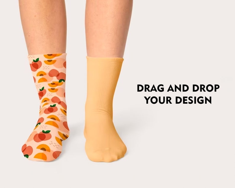 May include: A pair of socks, one with a peach pattern and the other plain yellow. The text "DRAG AND DROP YOUR DESIGN" is visible in the image.