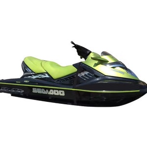 May include: A green and black Sea-Doo RXT 260 jet ski with a black and white flame design on the side. The jet ski has a black seat and a black windshield.