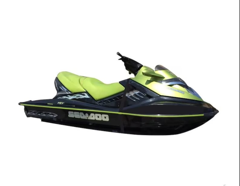 May include: A green and black Sea-Doo RXT 260 jet ski with a black and white flame design on the side. The jet ski has a black seat and a black windshield.