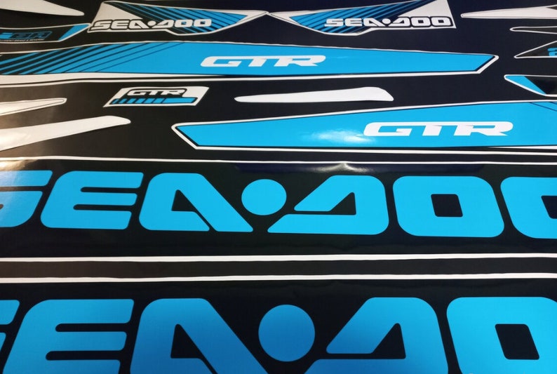 May include: A set of blue and white Sea-Doo GTR decals. The decals feature the Sea-Doo logo and the words "Sea-Doo" and "GTR".