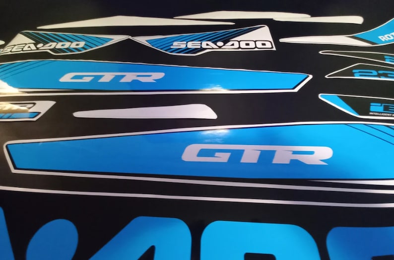 May include: A set of blue and white Sea-Doo GTR decals. The decals feature the Sea-Doo logo, the GTR logo, and the words "Intelligent Throttle Control".