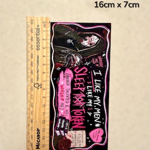 May include: A rectangular sticker, 16cm x 7cm, with a dark background and a gothic theme. The sticker features a hooded figure with a skull face, and text that reads "SLEEP MAN TOKEN" and "I LIKE MY MEN".