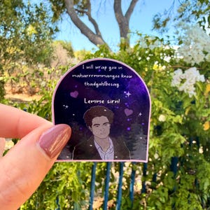 May include: A sticker with a purple and black background featuring a drawing of a man and text that reads "I will wrap you in maharrrrrmmanyoo know thadyuhlbessay. Lemme sirn!"