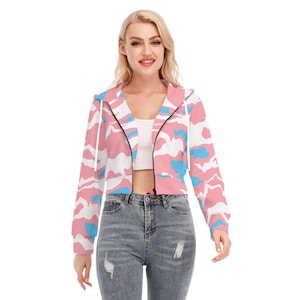 May include: A cropped hoodie with a zip fastening and a hood, featuring a pink, white and blue camouflage print.