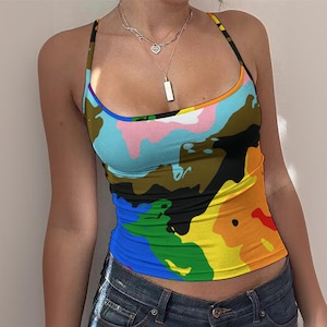 May include: A colorful camisole top with a vibrant, abstract pattern. The top features a rainbow of colors, including blue, green, yellow, orange, and red, with black and brown accents. The top has thin straps and a scoop neckline.