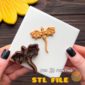 May include: A brown dragon-shaped cookie cutter and a light orange dragon-shaped cutout placed on a white square tile. The text FOR 3D PRINTING STL FILE is printed in yellow and white at the bottom of the image.