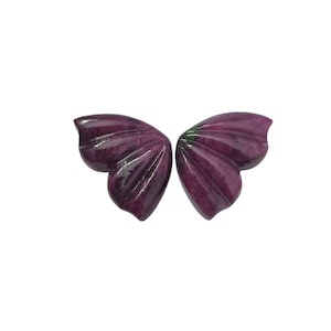 May include: Two matching, carved butterfly wings in a deep purple hue. The wings have a textured, ribbed design and a glossy finish. The wings are displayed against a white background.