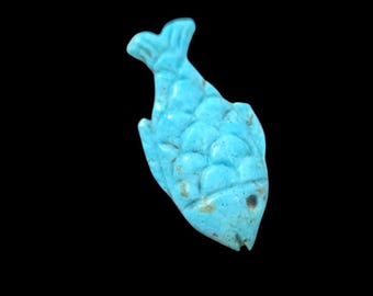 May include: A small, blue turquoise fish charm with a detailed, scaly design.
