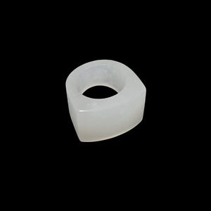 May include: A translucent, off-white ring with a geometric design. The ring has a rounded inner band and a flat, triangular outer shape. The ring is made of a solid, smooth material and is set against a black background.