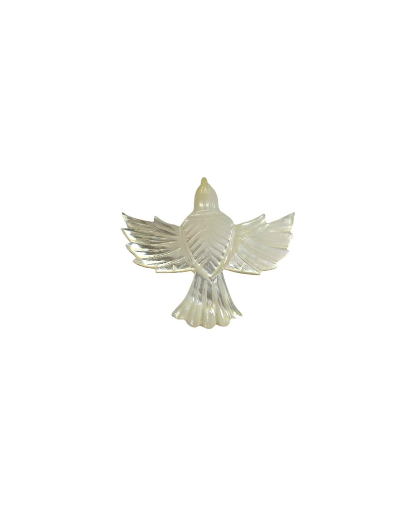 May include: A pearlescent, iridescent bird figurine with outstretched wings. The bird is depicted from a rear view, showcasing detailed feather patterns. The figurine is set against a plain white background, highlighting its form and design.