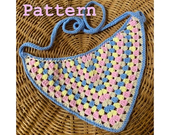 May include: Crochet pattern for a light blue, pink, yellow, and beige granny square scarf with a matching light blue strap.