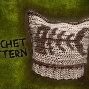 May include: Crochet pattern for a beige and brown cat-shaped hat with a fishbone design. The text "CROCHET PATTERN" is visible in the image.
