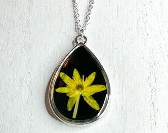 Silver pendant necklace with Bright yellow flower in black resin