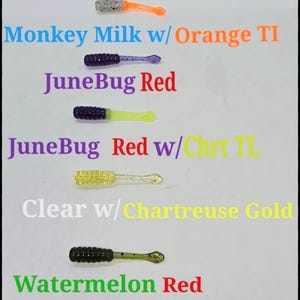 May include: Five different colors of fishing lures, each with a different color tail. The colors are: Monkey Milk w/Orange TI, JuneBug Red, JuneBug Red w/Chirt TE, Clear w/Chartreuse Gold, and Watermelon Red.